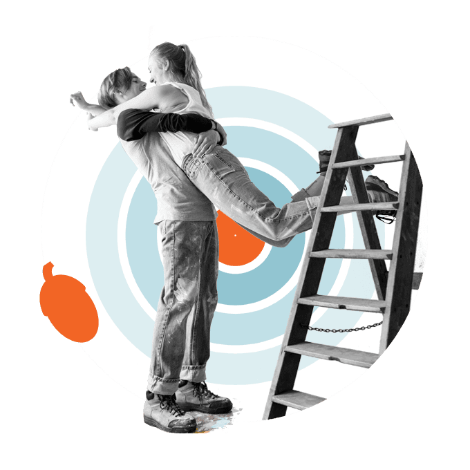 KiwiSaver first home buyer hugging while climbing a ladder, symbolising saving and support to buy a first home with KiwiSaver