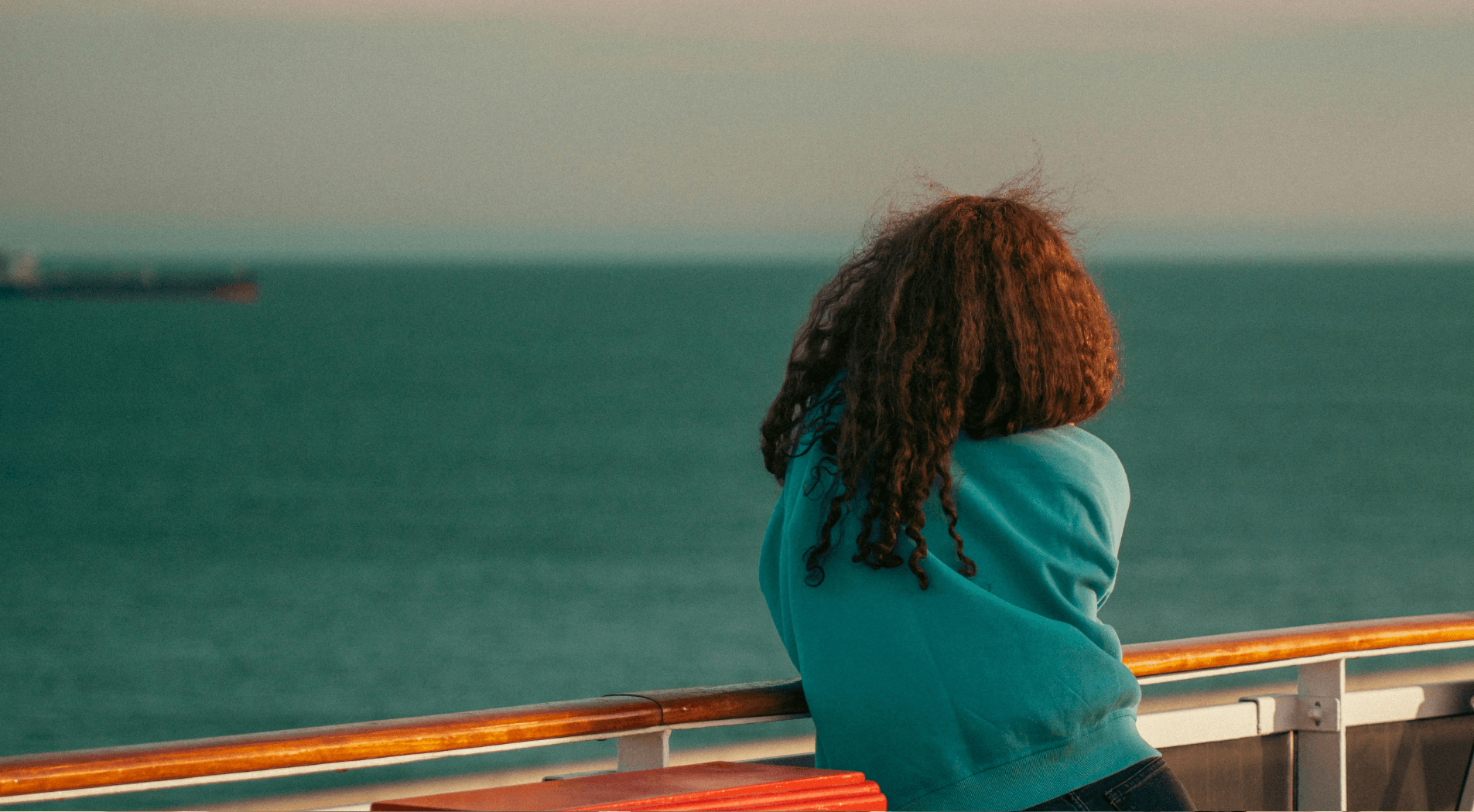 Contemplative person looking at the sea from a boat