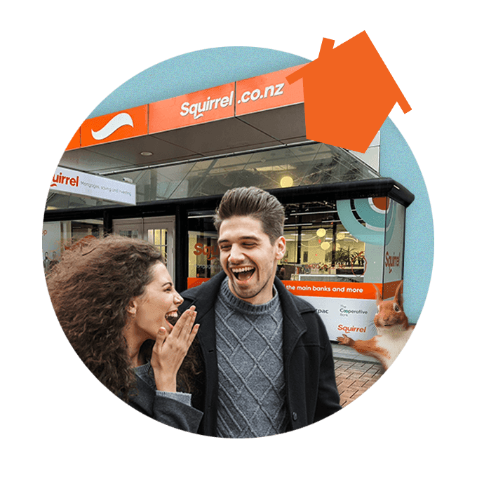 Two people laughing with each other with hair blowing in the wind, walking past Wellington Squirrel building. Squirrel popping out from the right hand side.