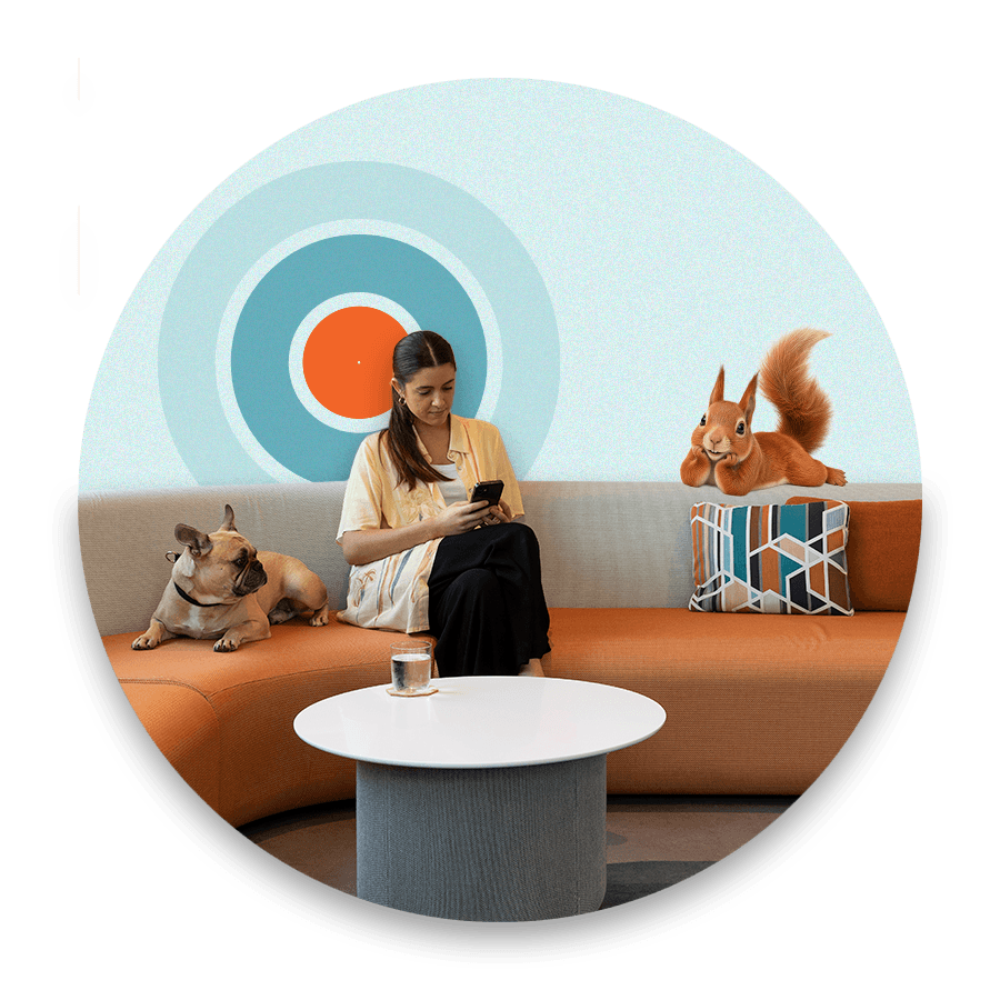 women sitting on her phone with dog to her right and Bernie the Squirrel to her left