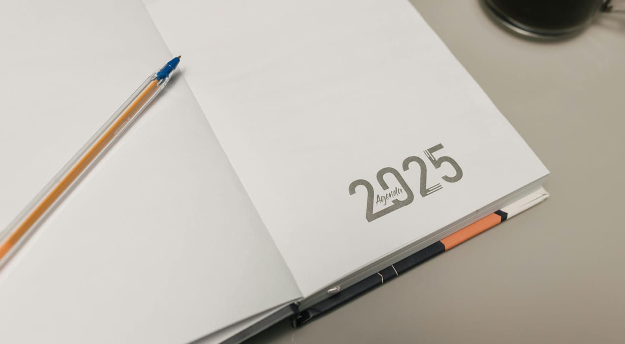 2025 diary on a desk next to a coffee