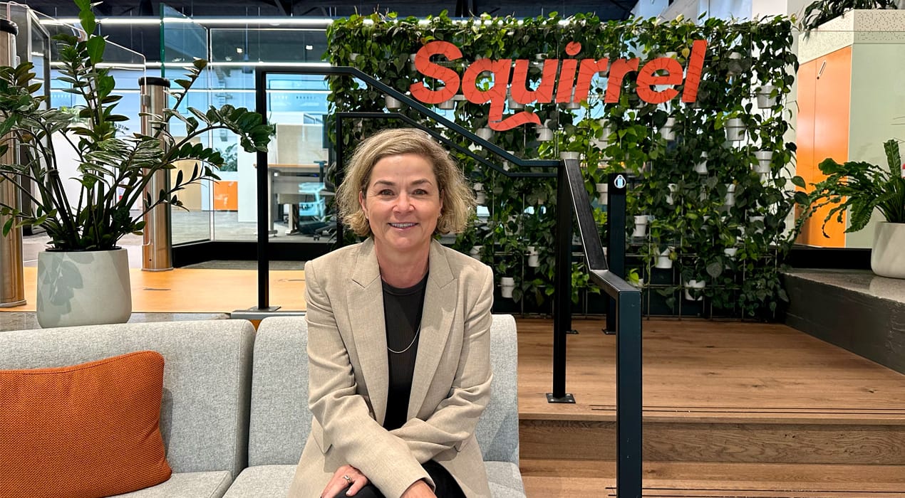 Photo of Abi Cooke, Squirrel's new Chief Marketing Officer in the foyer of Squirrel's Auckland HQ